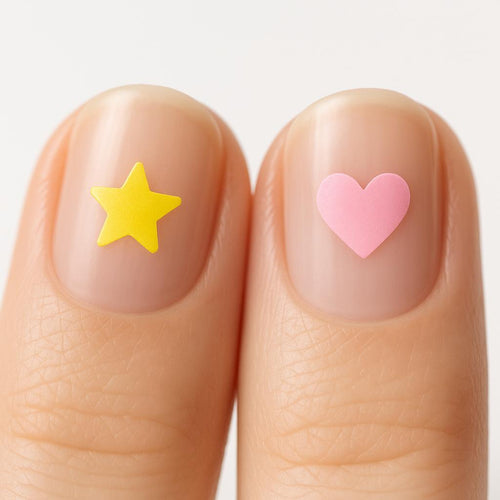 Close-up of a yellow star and a pink heart drink-test nail sticker